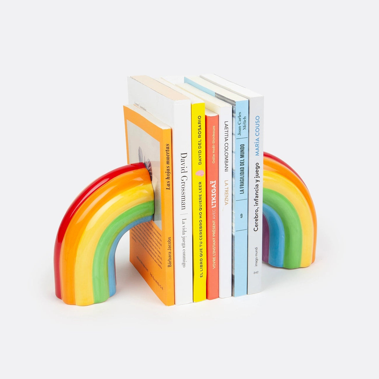 Rainbow-colored bookends holding books on a white background